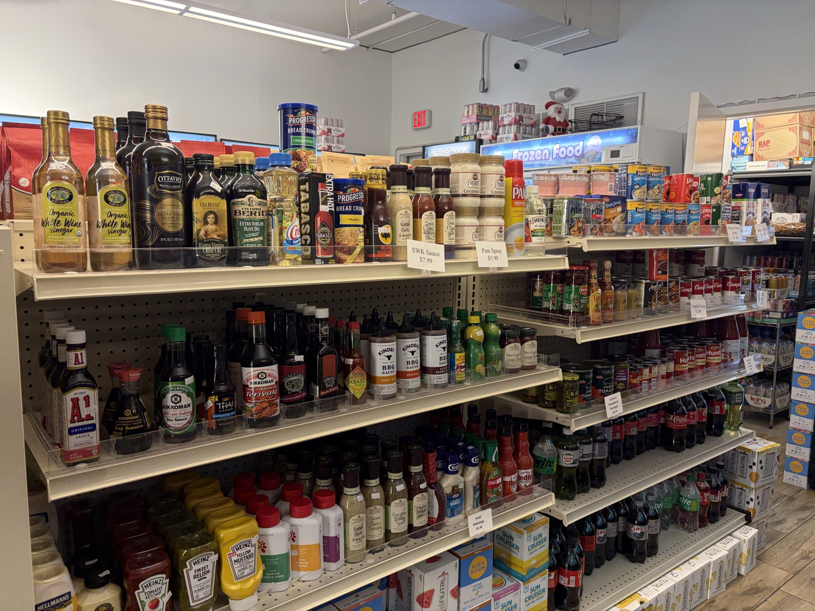 Shelves stocked with oils, sauces, condiments, and pantry staples