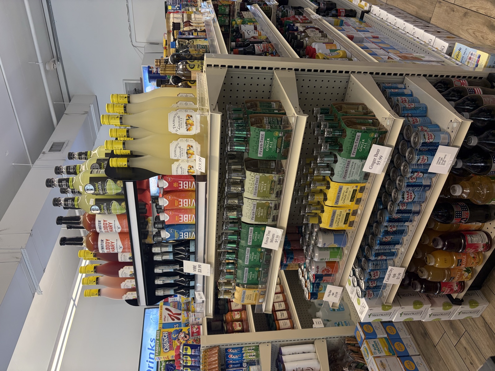 Pantry shelf with wines, mixers, and grocery items