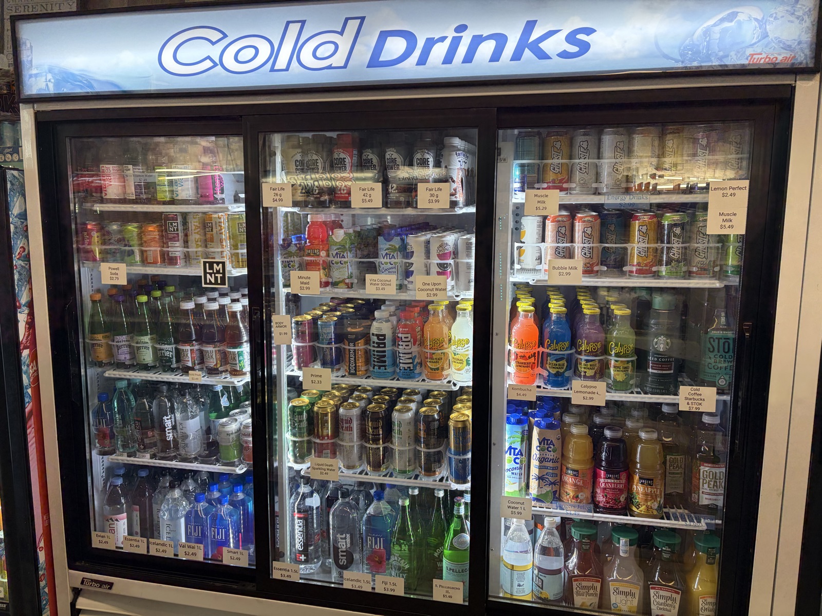 Cold drinks cooler stocked with bottled drinks at The Island Shoppe